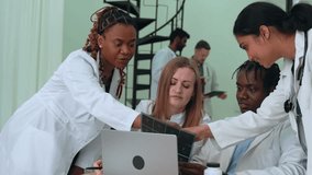 Medical team reviewing digital x-rays, collaborating near laptop, discussing diagnostic details in clinical workplace environment - Powered by Shutterstock - Get 15% off with code: PIKWIZARD15