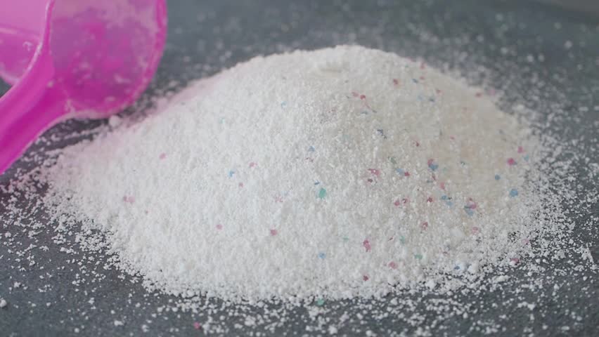 Close-up of White Laundry Detergent Powder and Measuring Scoop