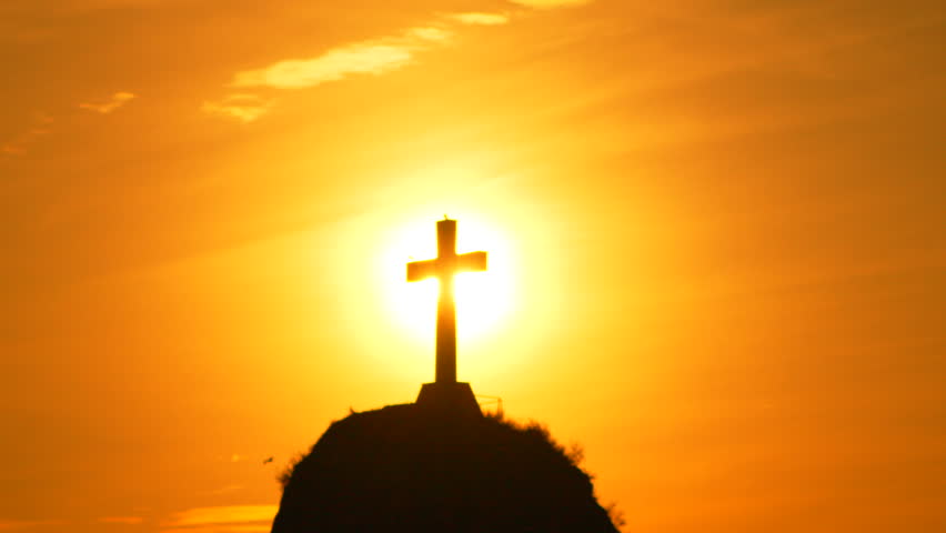 Cross Sunset Religion: Silhouette cross atop hill is viewed during sunset for spiritual reasons.