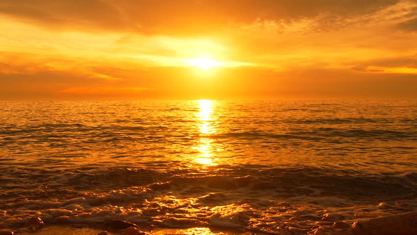 Sunset Ocean Beach: Golden hour sunset over ocean waves at beach, capturing scenic beauty.