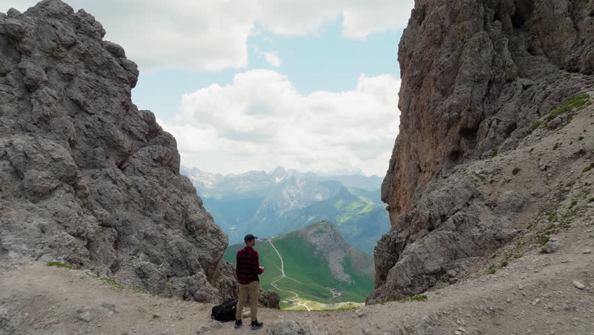 One man standing on top of Forcella del Sassolungo near Toni Demetz Hut, Dolomites, Italy
