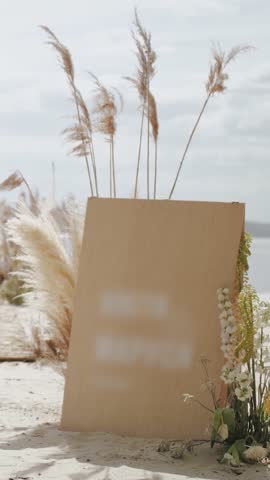 Wooden board for the names of the bride and groom. Romantic beach wedding with a gorgeous view of nature and the river, wedding decor.