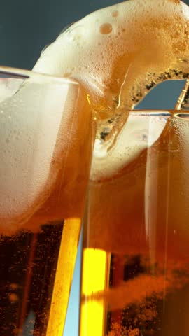 Super slow motion of beer glasses in cheers gesture. Filmed on high speed cinema camera, 1000 fps. Vertical aspect ratio.