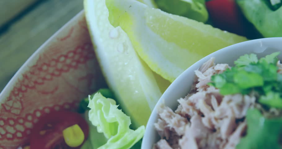 Flat design salad bowl showcasing tuna flakes and veggies being overlaid with green binary glitch. Healthy eating, fresh produce, digital technology, modern design, health food, culinary artistry,