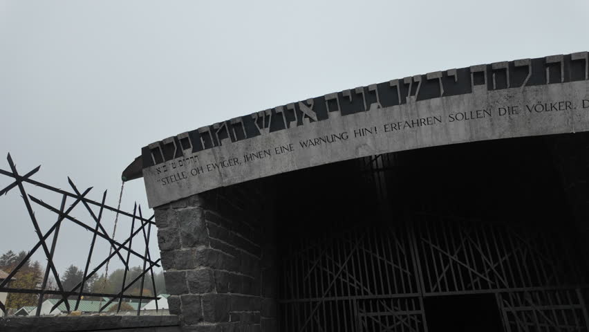 Dachau, Germany – Entrance to Jewish memorial at Dachau concentration camp, displaying a Hebrew and German inscription from Psalm 9:20, symbolizing remembrance and warning to future generations.