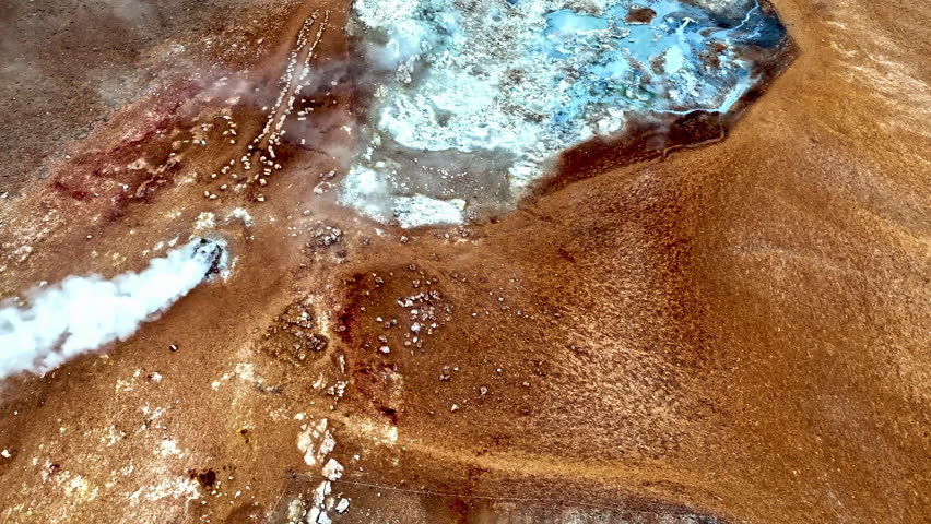 Drone rotating over smoking fumaroles and thermal pools of Hverir, Iceland