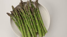 fresh asparagus top view on plate rotation food - Powered by Shutterstock - Get 15% off with code: PIKWIZARD15