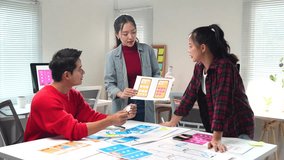 User experience designers collaborating on mobile app interface prototype, brainstorming digital design strategy in bright contemporary startup office workspace - Powered by Shutterstock - Get 15% off with code: PIKWIZARD15