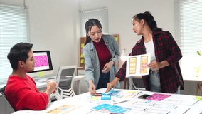 Professional web designers collaborating on mobile app design sketches, sharing innovative ideas and analyzing project wireframes in bright modern startup office environment - Powered by Shutterstock - Get 15% off with code: PIKWIZARD15