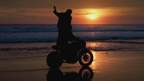 Romantic couple rides a motorcycle on a sand beach, holding red warning light. Man, woman drive stylish retro bike along ocean or sea shore, burning torch. Male, female in road trip on tropical island - Powered by Shutterstock - Get 15% off with code: PIKWIZARD15