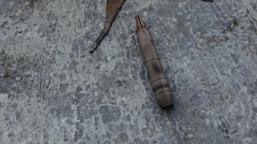 Sickle or grass hook, large, damaged handle, rather long, made of wood and thin iron, vintage, old, slightly moldy, brown rusty and rough. Angle 1