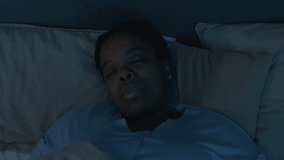 Top down shot of distressed Black woman suddenly waking up in bed, looking at camera and rubbing her forehead while having nightmare - Powered by Shutterstock - Get 15% off with code: PIKWIZARD15