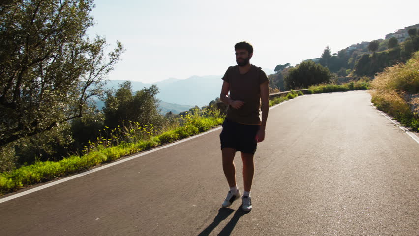 Athlete Trains Under The Sun Walking Backwards