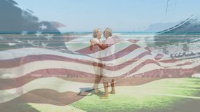 Senior couple dancing on sand, with American flag overlay, stands, ocean waves for health marketing. Romance, celebration, patriotism, outdoor, leisure, vitality, scenic - Powered by Shutterstock - Get 15% off with code: PIKWIZARD15
