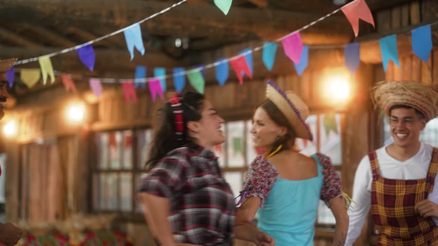 Festive Spirits High as Couples Swing in Sync at Festa Junina. Traditional Garb and Lively Steps Illuminate the Rustic Dance Hall with Brazilian Flair