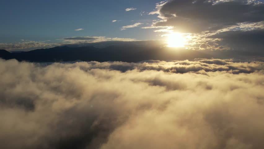Flying down over sunrise cloudscape. The concept of freedom, flight, movement, success