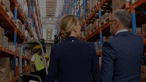 Businesswoman and forklift operator touring logistics warehouse, displaying animated network icons. Industrial, logistics, supply chain, digital, operational, technology, professional - Powered by Shutterstock - Get 15% off with code: PIKWIZARD15