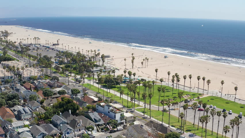 Aerial moving shot of Santa Monica Los Angeles beach coast, palm trees, homes - Aerial Drone View