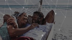 couple lounging on hammock near beach shoreline, showcasing technology network overlay. Romantic, relaxation, tranquility, digital, connectivity, leisure, scenic - Powered by Shutterstock - Get 15% off with code: PIKWIZARD15