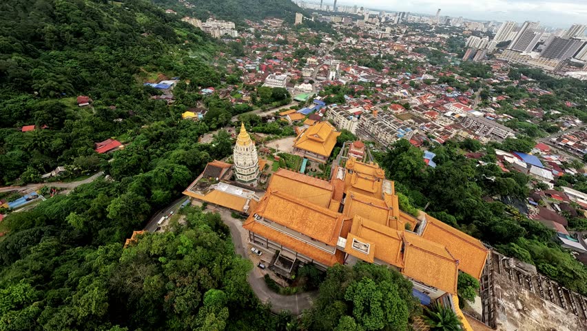 FPV shot of Kek lok si temple, a beautiful buddhist temple in penang, malaysia, displays its intricate architecture and vibrant colors. Translation: Temple of Supreme Bliss