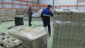 Huge Storage room at the Food Manufacturing Facility. A Worker is Moving the Cart full of Dairy Products inside of the Storage room. Keeping the Product in the Storage room. Milk Industry. - Powered by Shutterstock - Get 15% off with code: PIKWIZARD15