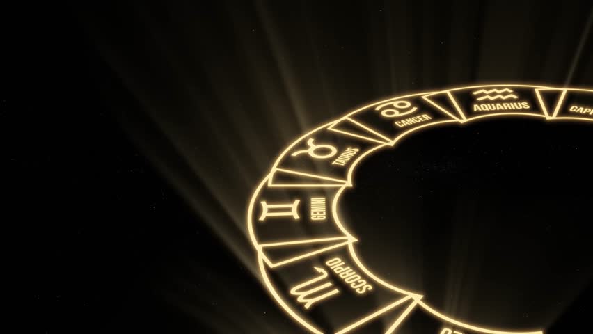 Zodiac wheel with glowing astrological symbols and rays of light on the background of the starry sky. 4K