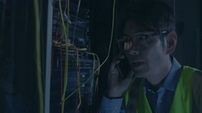 Network technician holding phone handset near ethernet cables, displaying green terminal interface. Technology, cybersecurity, data, infrastructure, digital, connectivity, professional - Powered by Shutterstock - Get 15% off with code: PIKWIZARD15