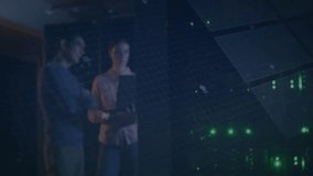 Two tech professionals interacting in control center, with holographic charts and circuit lines. Technology, innovation, data visualization, futuristic, collaboration, digital, enterprise - Powered by Shutterstock - Get 15% off with code: PIKWIZARD15