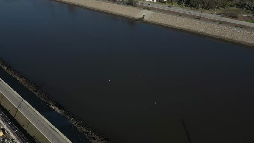 Drone shows Long Beach city touching the Pacific Ocean at golden hour.
