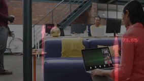 Coworkers collaborating in business lounge, viewing animated finance graphs with red overlays. Collaboration, coworking, modern, urban, professional, networking, startup - Powered by Shutterstock - Get 15% off with code: PIKWIZARD15