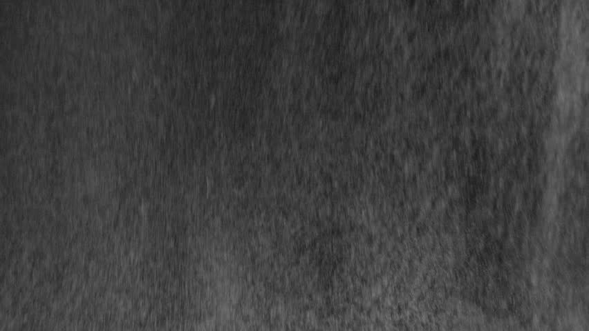 Night Shower in the Light of a Lantern. Heavy night rain with wind in the headlights on a black background