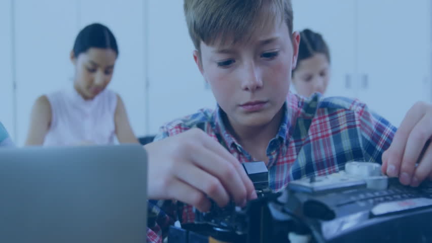 students assembling robotics kit at workbench in tech classroom, with floating social media icons. Stem, education, innovation, collaboration, youth, technology, creativity