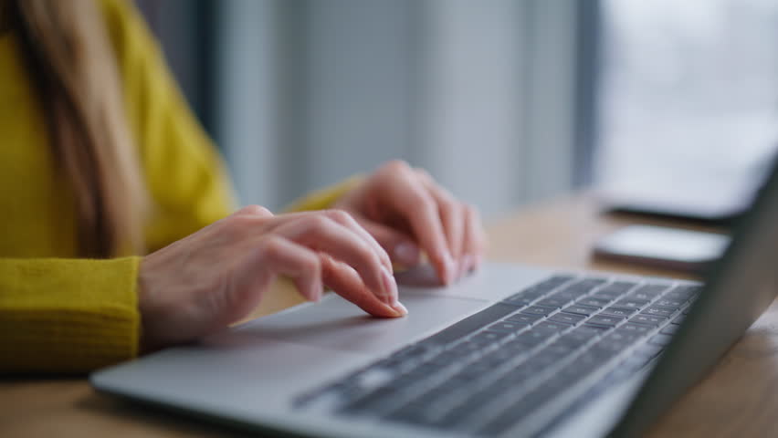 Woman hands using touchpad laptop surfing internet at workplace closeup. Smiling businesswoman working on creative project feeling satisfied. Happy freelancer enjoy online job sitting apartment desk.