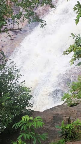 A beautiful waterfall from the side view of it. 