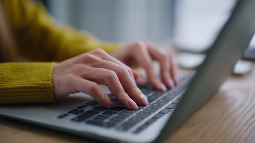 Businesswoman hands writing email on laptop at corporate office space closeup. Unrecognizable woman typing on keyboard browsing internet website. Female freelancer working online on apartment desk.