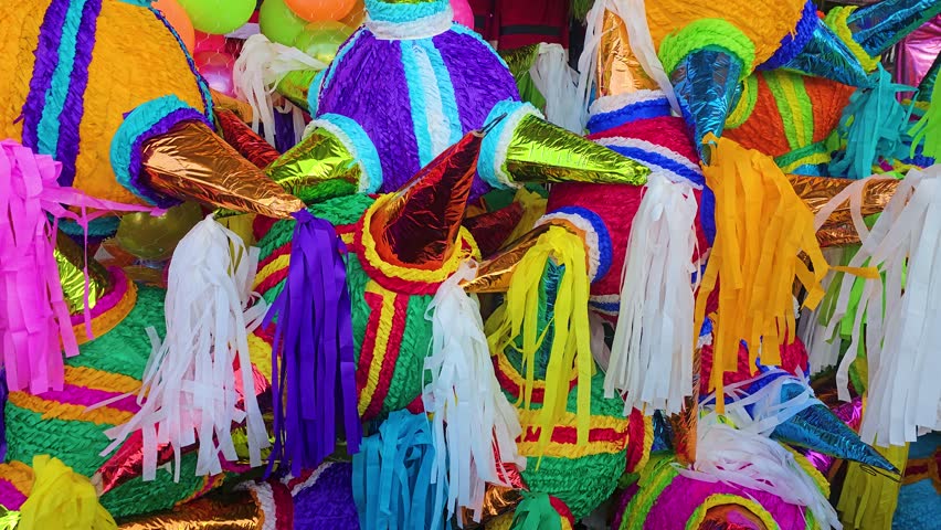 Traditional star-shaped piñatas in dazzling colors fill a market stall, ready for celebrations and cultural festivities.