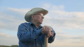 Aged American farmer leans on his stick at sunset, alone in the field. A deep portrait of a man connected to earth, time, and his unspoken story. - Powered by Shutterstock - Get 15% off with code: PIKWIZARD15