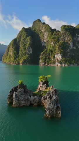 Experience the breathtaking and stunningly beautiful drone views showcasing crystalline waters and magnificent limestone formations in the tropical paradise of Phuket, Thailand, a true wonder for all