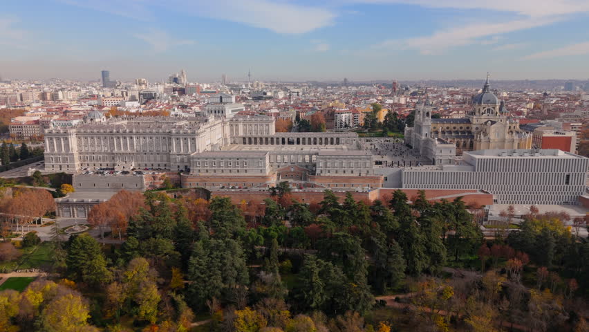 Aerial shots beautifully capture the stunning Royal Palace of Madrid, highlighting its impressive medieval design alongside the nearby iconic Santa Maria la Real de La Almudena Cathedral