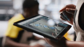 Black photovoltaics factory technician monitoring system performance on tablet. Solar panels manufacturing plant supervisor pleased by high production, inspecting efficiency. Camera A. - Powered by Shutterstock - Get 15% off with code: PIKWIZARD15