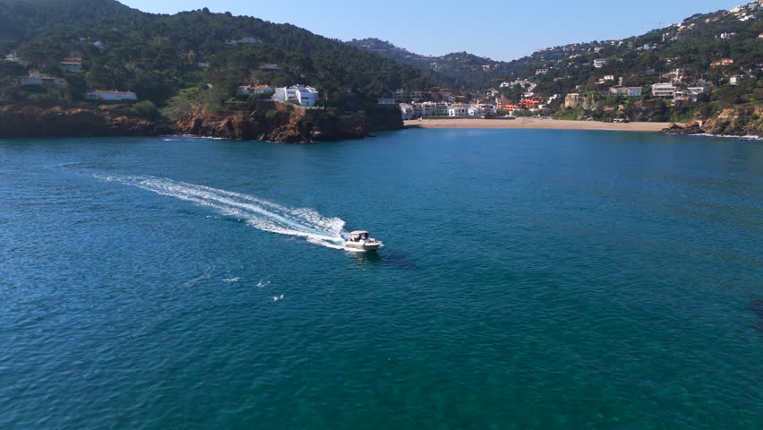aerial footage of a boat cruising along the beautiful costa brava coastal line, Begur, Catalonia