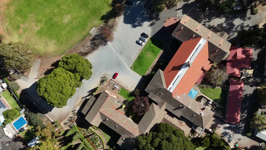 St Paul’s Catholic Church and Monastery Memorial Garden in Urrbrae, South Australia in autumn – 4k Aerial Footage of trees, parklands, and historic buildings near Waite Campus and the Adelaide Hills.