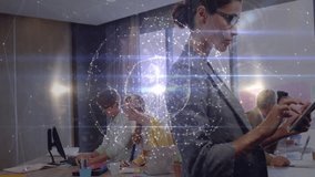 Businesswoman using tablet in modern business meeting, showing animated network graphs and globe. Corporate, collaboration, digital, networking, innovation, professional, workspace - Powered by Shutterstock - Get 15% off with code: PIKWIZARD15