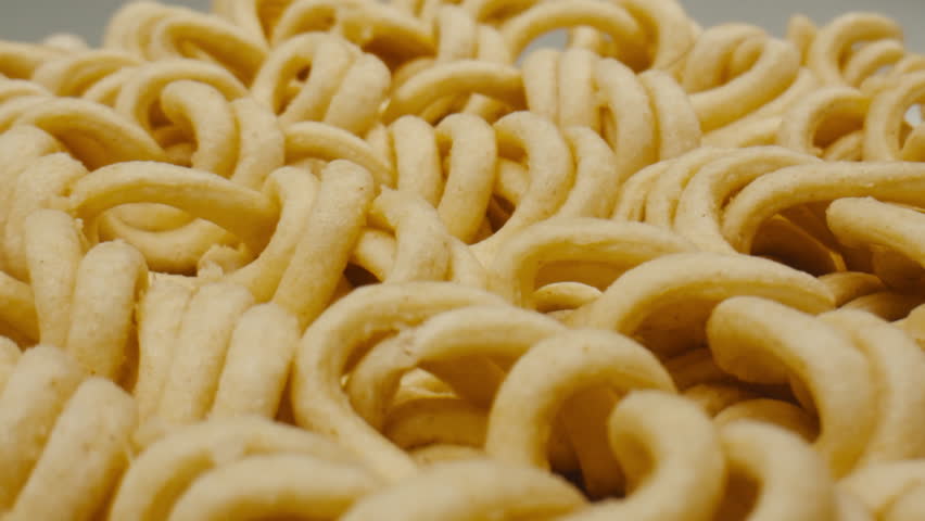 Cooking instant noodles in boiling water with spices close-up. Asian fast food. Instant noodles, or instant ramen, is a type of food consisting of noodles sold in a precooked and dried block with