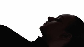 Vertical video. Sad silhouette. Anxiety stress. Loneliness depression. Dark contrast profile face outline of tired upset woman stretching neck isolated on white free space. - Powered by Shutterstock - Get 15% off with code: PIKWIZARD15