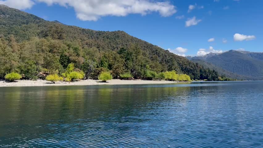 Lago Lacar Quila Quina in Argentina, showcasing calm waters, lush greenery, and mountains