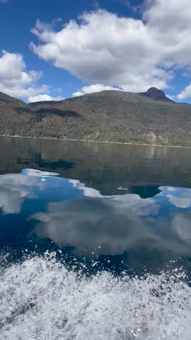 Lago Lacar Quila Quina boat ride with mountains reflecting in the serene lake