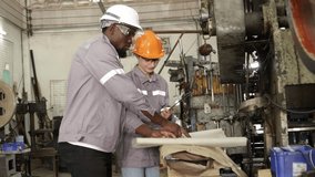 Male and female mechanic industrial spare parts factory technicians work together to inspect equipment parts blueprints machinery data manuals in a factory in the industry for scheduled maintenance. - Powered by Shutterstock - Get 15% off with code: PIKWIZARD15