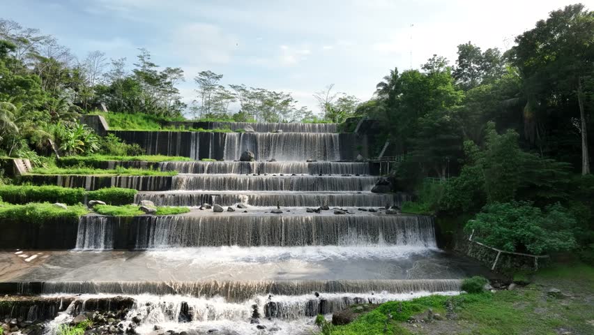 Aerial view of Grojogan Watu Purbo in Sleman, Yogyakarta, Indonesia. A six-tiered artificial waterfall surrounded by nature. Popular travel destination and local tourist attraction.