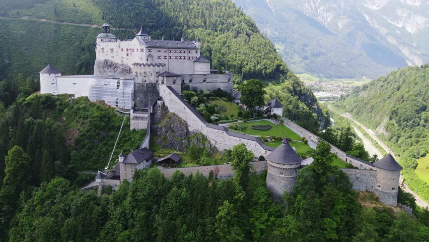 Magnificent castle architecture perched on mountain slope in heart of Austrian Alps